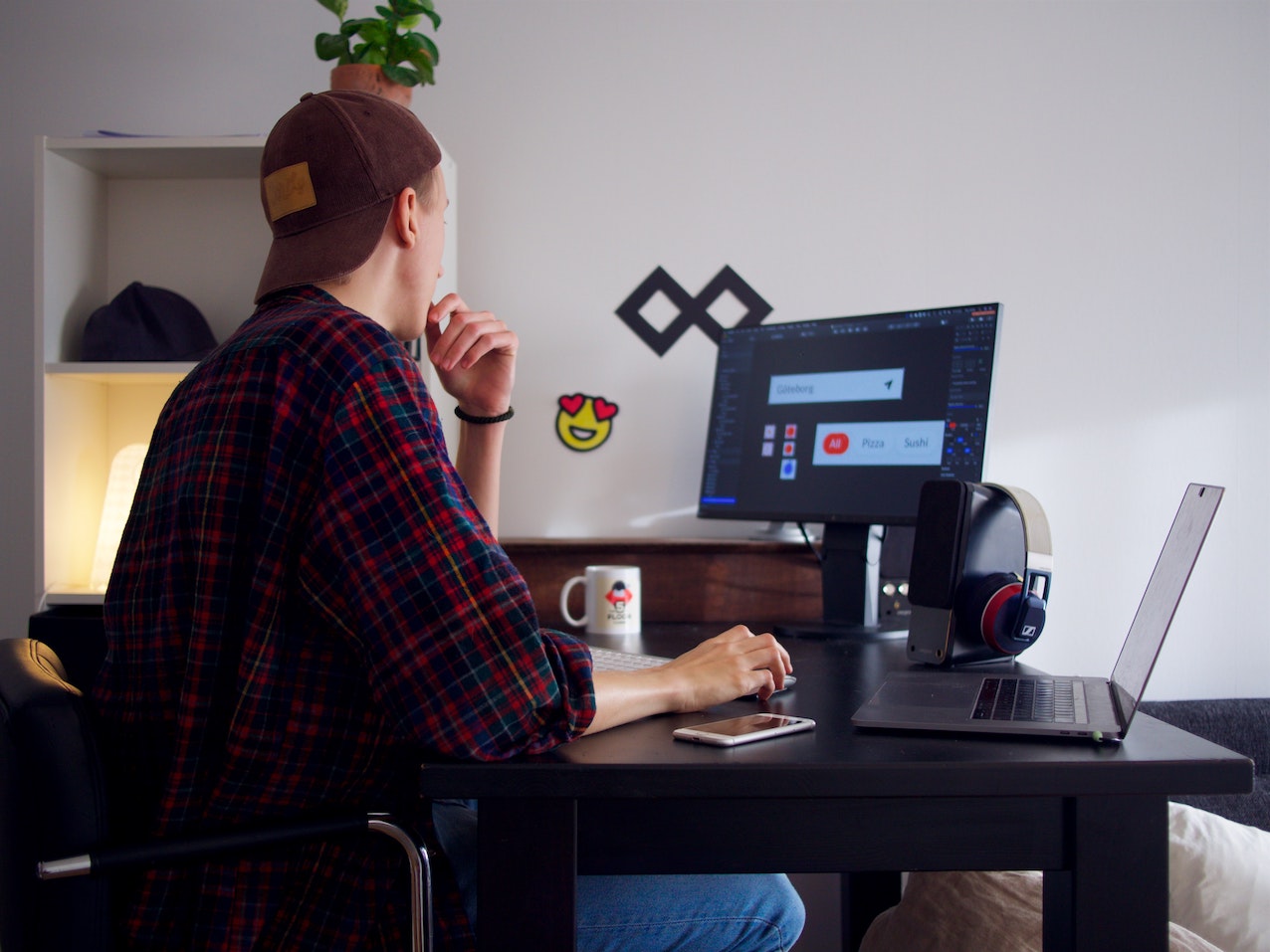 a freelancer web designer in his office doing client work