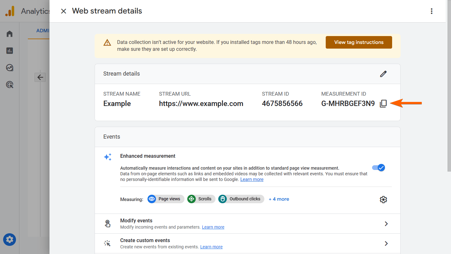 An arrow pointing to the measurement ID in Google Analytics