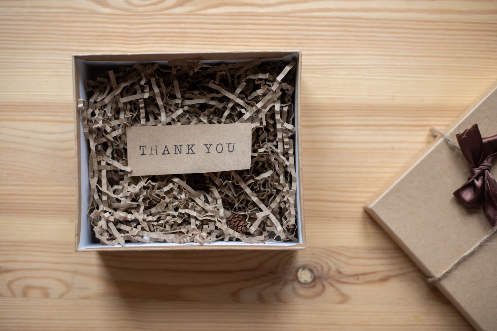 A cardboard gift box displaying a "Thank You" message in it