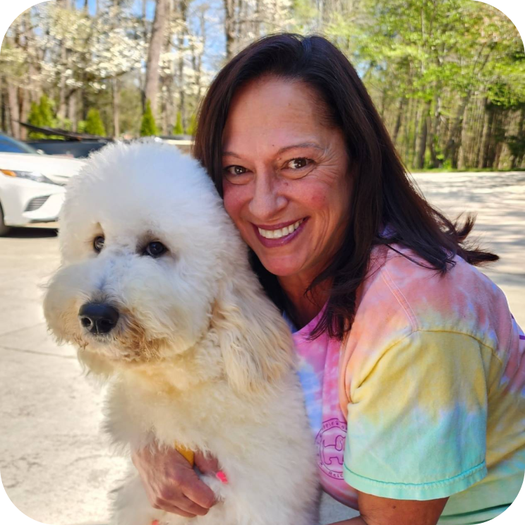 Woman hugging a dog in an outdoor setting