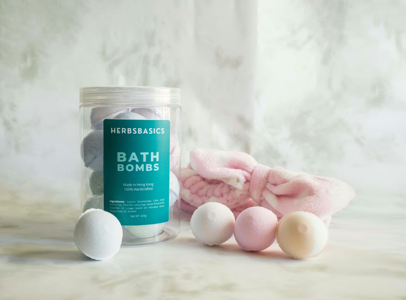 Bath bombs arranged around a jar on a marble surface